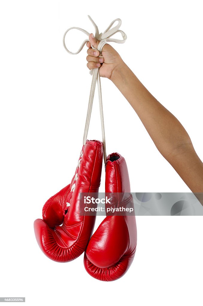 Red boxing gloves hanging isolated on white Red boxing gloves on white background 2015 Stock Photo