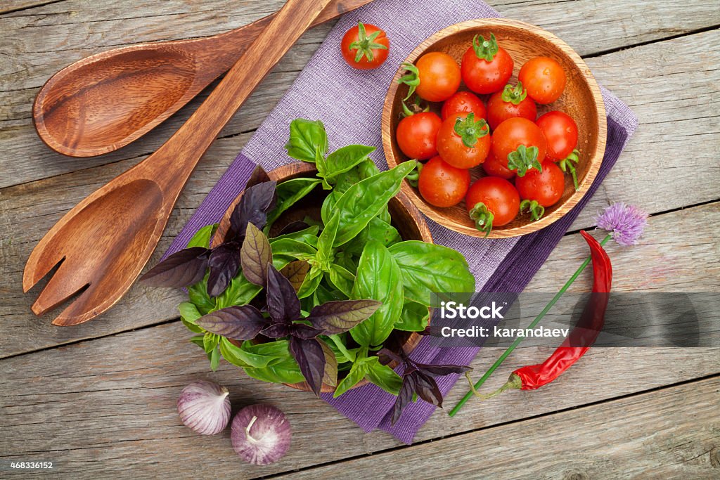 Fresh farmers tomatoes and basil Fresh farmers tomatoes and basil on wood table 2015 Stock Photo