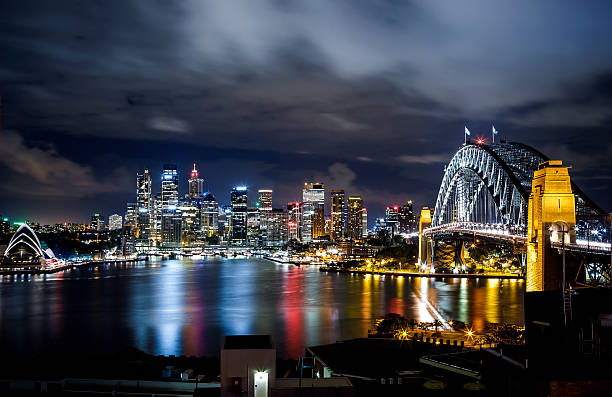 Sydney harbor and downtown buildings in Sydney at night, Australia.