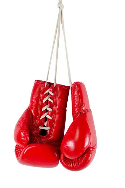 Photo of Hanging red boxing gloves on white background