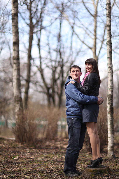istock lovers kissing in the park 468337372