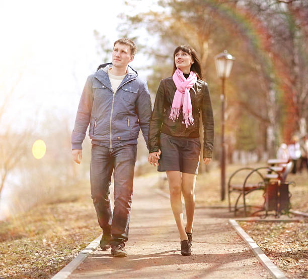 istock lovers walking in the park 468337422