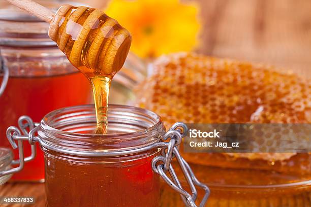 Honey In Jar With Honeycomb And Wooden Drizzler Stock Photo - Download Image Now - Anise, Apiculture, Bowl