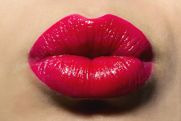 istock Woman with puckered lips and red lipstick 468337849