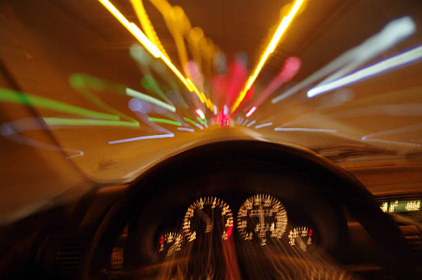 Blurred motion car drivers view traveling through tunnel tunnel car motion blur night traffic fast driving under the influence stock pictures, royalty-free photos & images