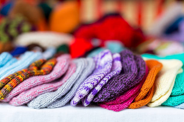 istock Hand-knitted multicolored baby socks lined up in a row 468338122