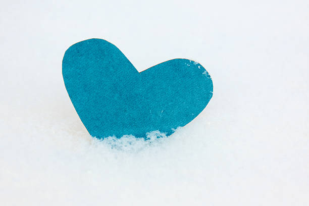 istock One heart shape from blue paper in the snow 468339265