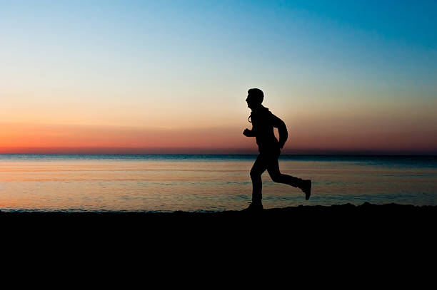 istock Silhouette of man jogging 468342572