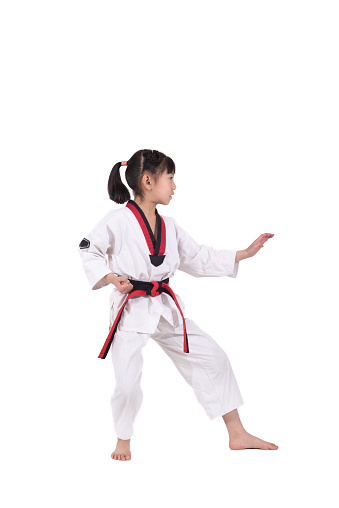 The little girl is practising Taekwondo.
