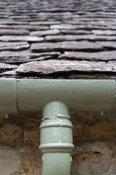 istock Cotswold stone tiles above an old Iron guttering joint 468346458