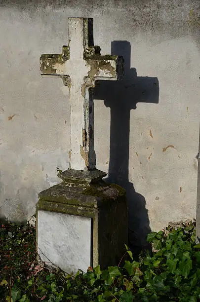 old stone cross on a cemetery
