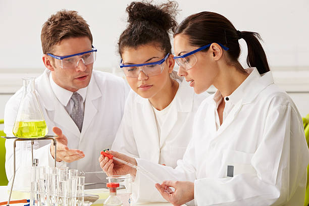 istock Group Of Scientists Performing Experiment In Laboratory 468346513