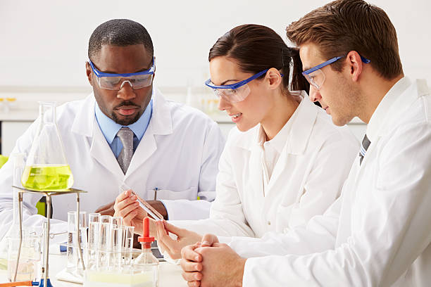 istock Group Of Scientists Performing Experiment In Laboratory 468347501