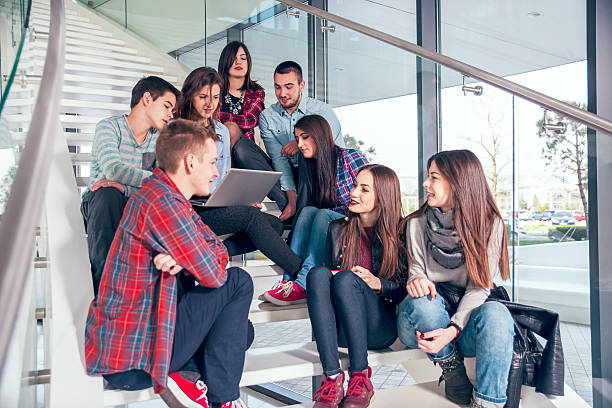 istock Medium group of  students studying on steps of school building. 468347572