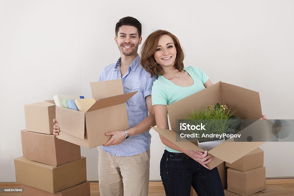 Young Couple Holding Cardbox Young Happy Couple Holding Moving Into New House Adult Stock Photo