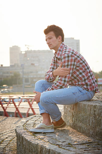 istock Handsome man outdoors sitting on stone stairs 468347934