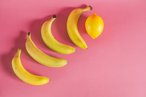 istock bananas and lemon on pink background 468348080