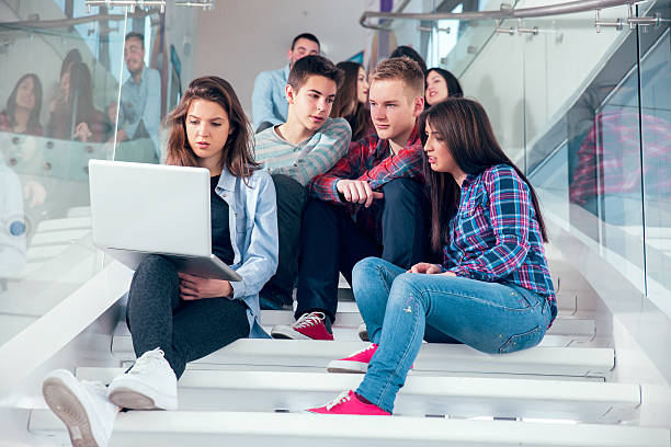 istock Medium group of  students studying on steps of school building. 468348150