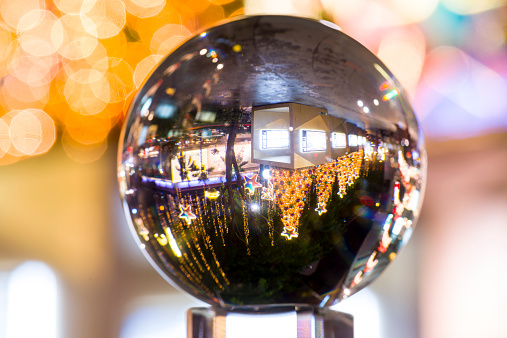 Reflection of Orchard Road with Christmas decoration during night time in a glass ball, showing busy and colourful Orchard Road, Singapore during festive season.