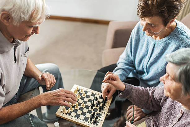 istock High angle view of senior people playing chess. 468350408