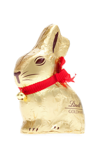 Biedermannsdorf, Austria - March 29, 2011: Golden Lindt chocolate easter rabbit with red ribbon and golden bell isolated on white