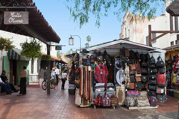 Los Angeles, California, US - December 2, 2013: People browse the many shops on Olvera Street, a California State Historical Landmark., on a warm December afternoon. It is a popular tourist attraction, being one of the oldest sections of Los Angeles with dozens of shops selling a wide variety of Mexican goods.