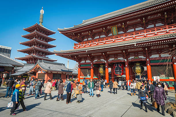 Tokyo Senso-ji temple pagoda tourist crowds Akasuka Japan Tokyo, Japan - 28th January 2014: Crowds of visitors to the iconic Senso-ji temple and five storey pagoda in the Asakus district of downtown Tokyo, Japan's vibrant capital city. sensoji stock pictures, royalty-free photos & images