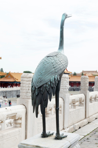 Bronze crane in front of pagoda in Forbidden City