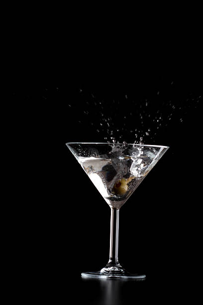 istock Splash in martini glass on black background 468352778