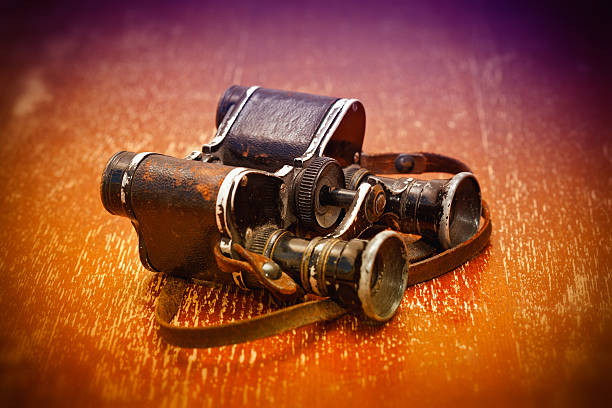 istock Old military binoculars on a bright orange background 468354040