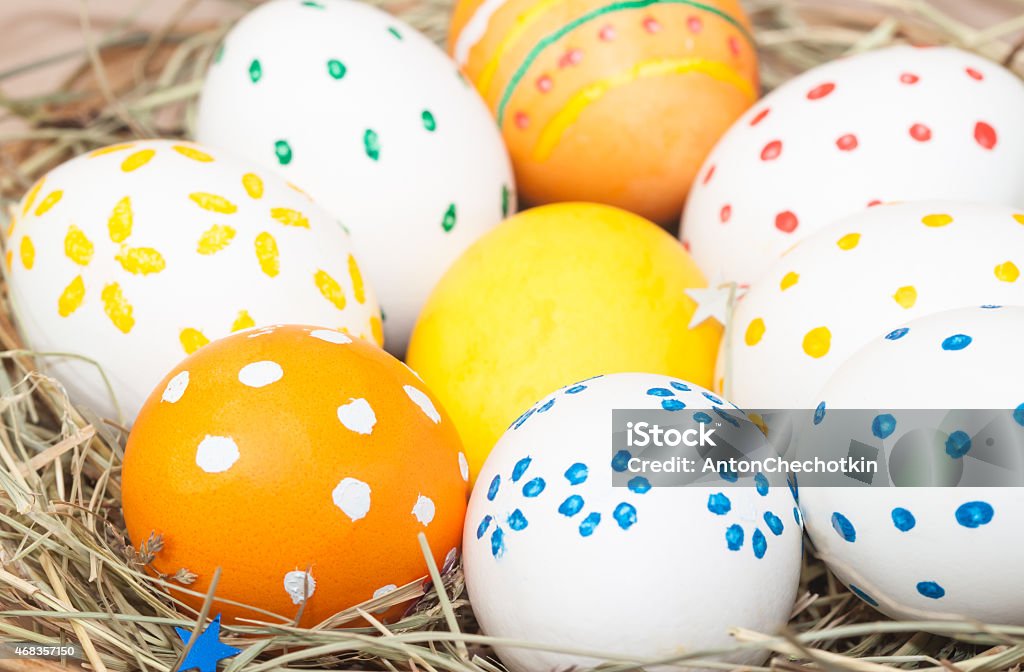 colored easter eggs in basket colored easter eggs in basket with hay 2015 Stock Photo