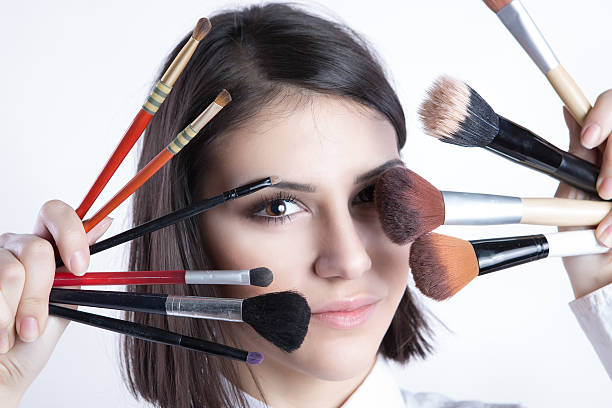 istock Beauty girl with makeup brushes 468357370