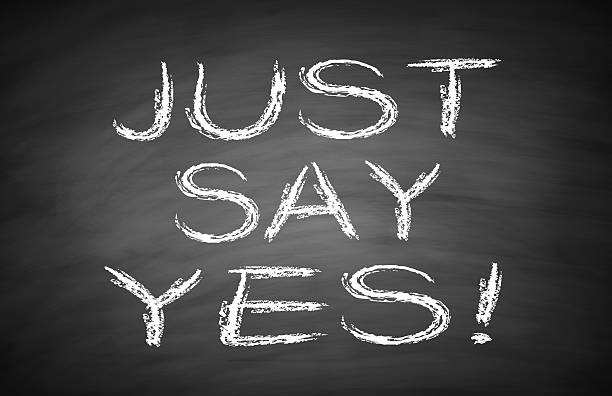 Just say yes Just say yes text is written by white chalk on blackboard. man writing on white board stock pictures, royalty-free photos & images