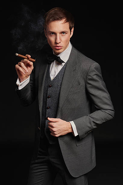 istock Studio portrait of young man smoking a cigar 468359112