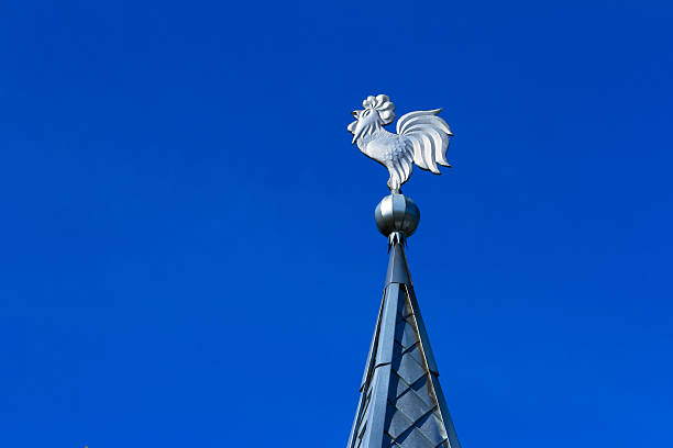Weathervane made of tin on the top of a spire.