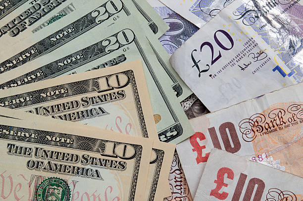 UK Pound and United States Ten and Twenty Dollar bills. United States Ten and Twenty Dollar notes next to Ten and Twenty UK Pound Notes british currency stock pictures, royalty-free photos & images