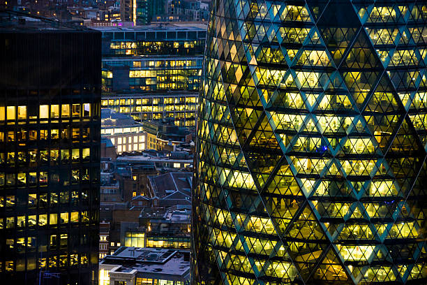 Skyscraper by night The Gherkin and surroundings illuminated by lights after dark in London london gherkin at night stock pictures, royalty-free photos & images