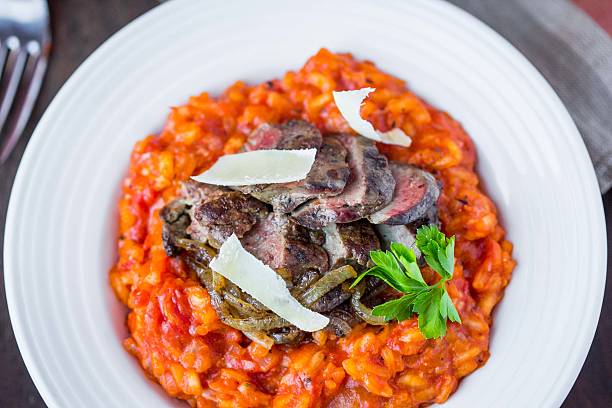 istock Tomato risotto, red rice with fried chicken liver, onions 468363012