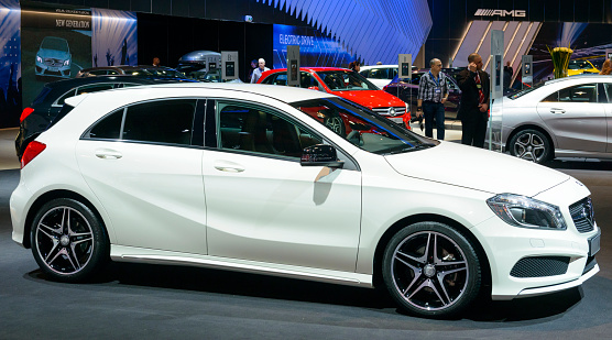 Brussels, Belgium - January 15, 2015: Mercedes-Benz A-Class hatcback car on display during the 2015 Brussels motor show. People in the background are looking at the cars.
