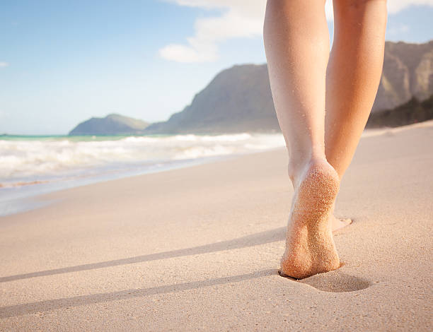 istock woman waliking on a beautiful beach 468363650