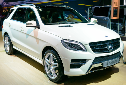 Brussels, Belgium - January 15, 2015: Mercedes Benz M-class ML 250 BlueTec SUV on display during the 2015 Brussels motor show. People in the background are looking at the cars.