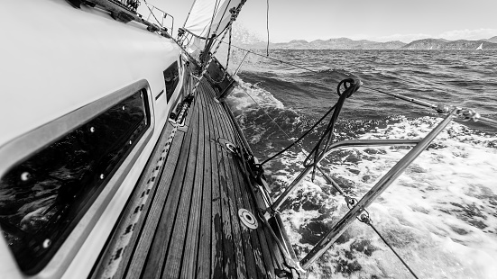 Yacht in race on the sea. Black and white photography.