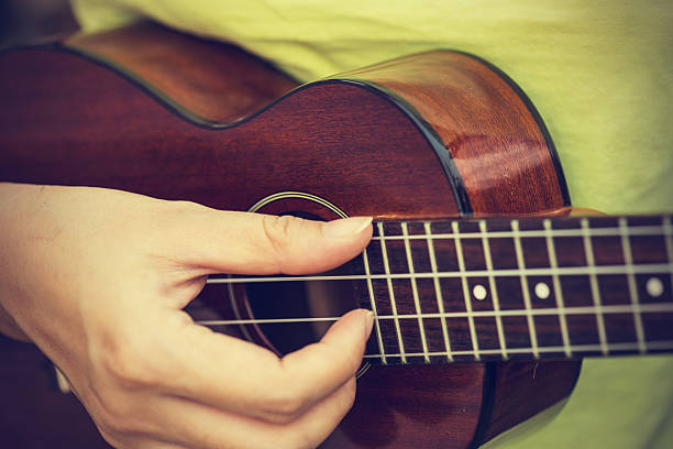 istock Woman playing ukulele, vintage style. 468368488