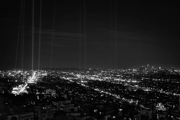 Hollywood and Downtown Los Angeles at night with spot lights Hollywood, west hollywood, and downtown los angeles at night in black and white.  Spot lights are aimed into sky and placed along the route of the 30th anniverary of the LA marathon sunset strip stock pictures, royalty-free photos & images