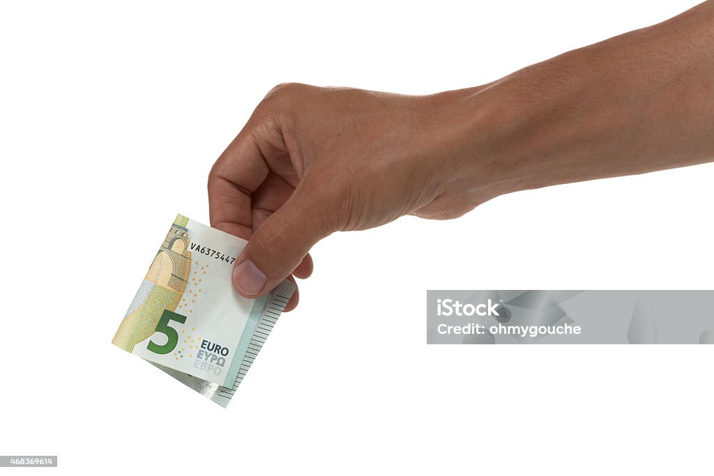 Hand holding out a 5 euro bill Hand holding out 5 euro bill folded in half 2015 Stock Photo