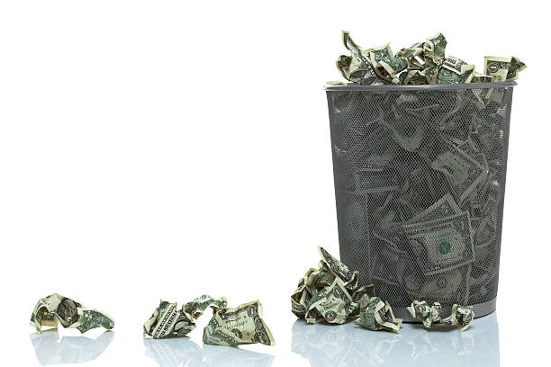 Garbage can full of money spilling over
