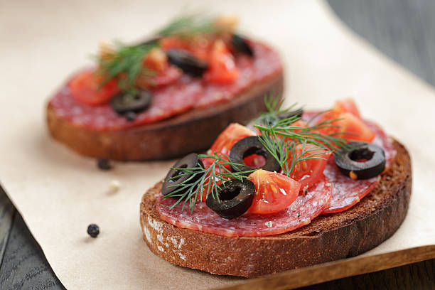 istock open rye sandwich with salami and vegetables 468372378