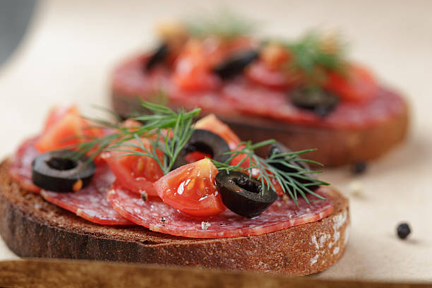 istock open rye sandwich with salami and vegetables 468372390