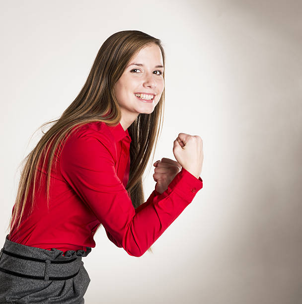 Successful business woman is standing on isolated background.