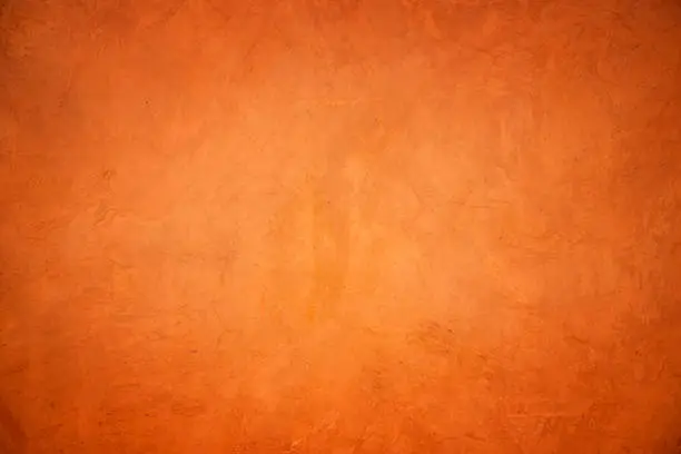 Photo of Orange grunge concrete wall textured and background.